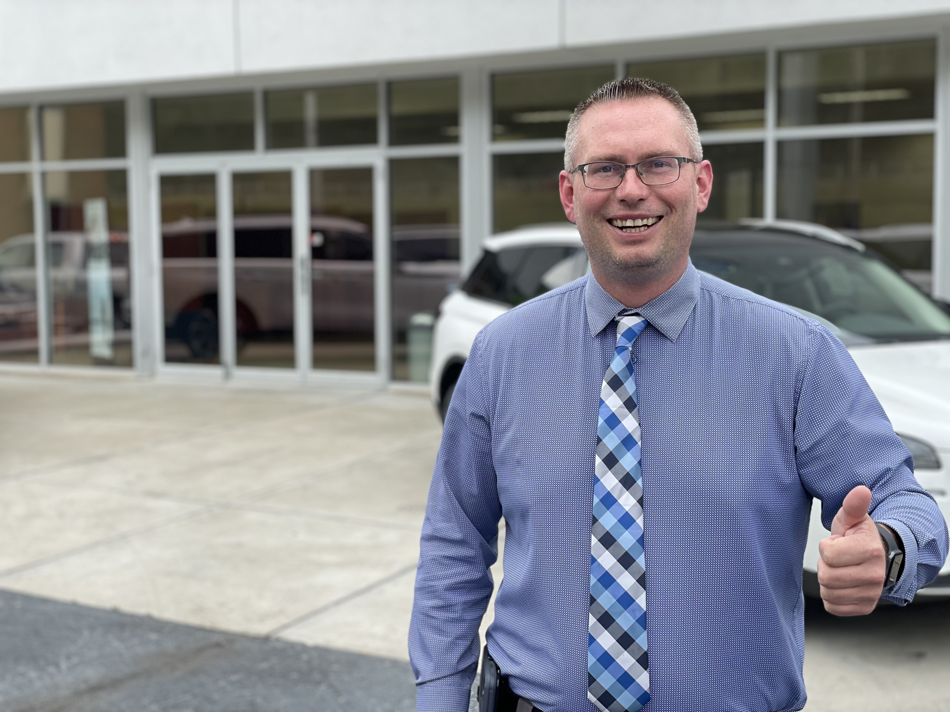 Joshua Harvey giving a thumbs up outside Walters Auto Group in Pikeville, KY